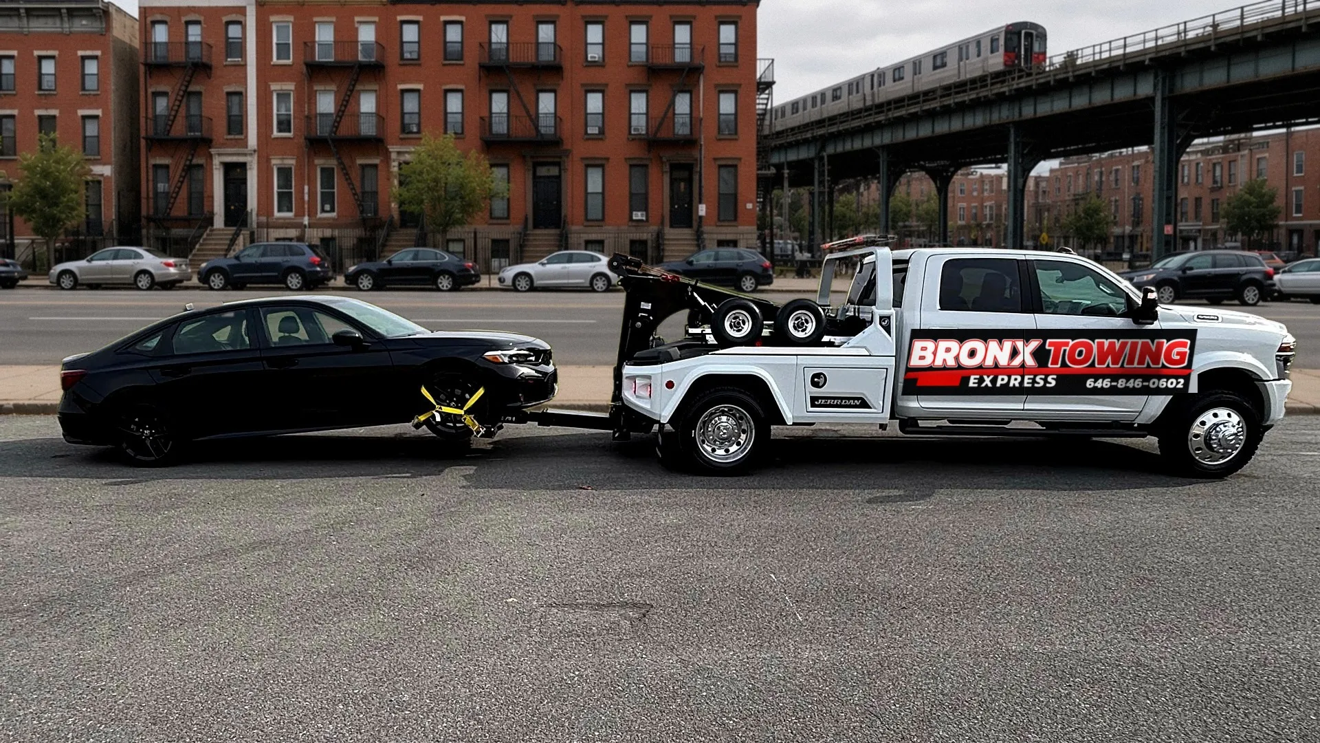 Bronx Towing Express tow truck towing a sedan on a Bronx street