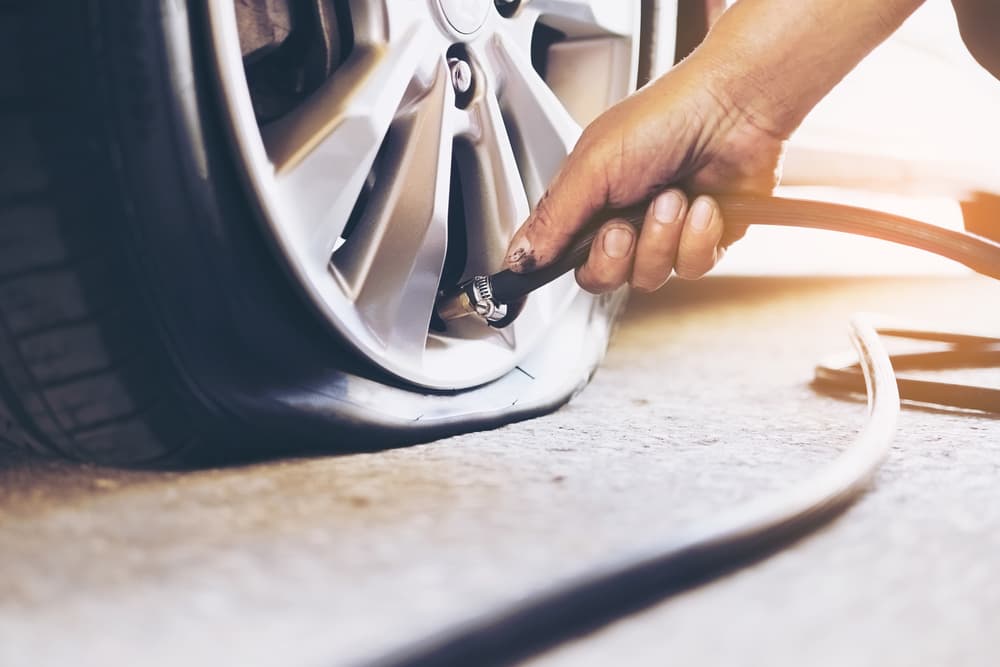 Technician performing tire repair services.